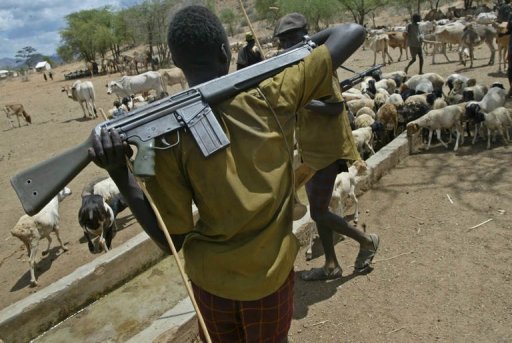Turkana man protecting herd of goats